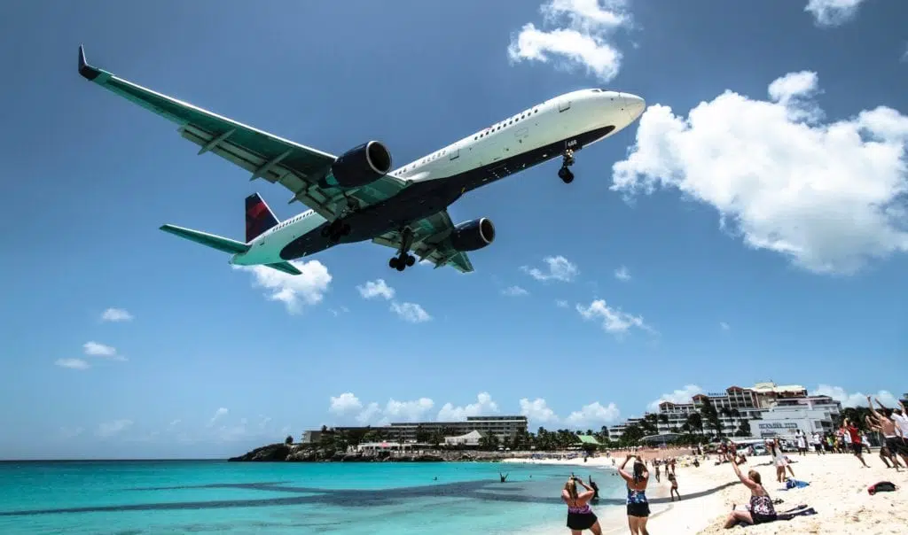 A large delta air plane flying in the sky