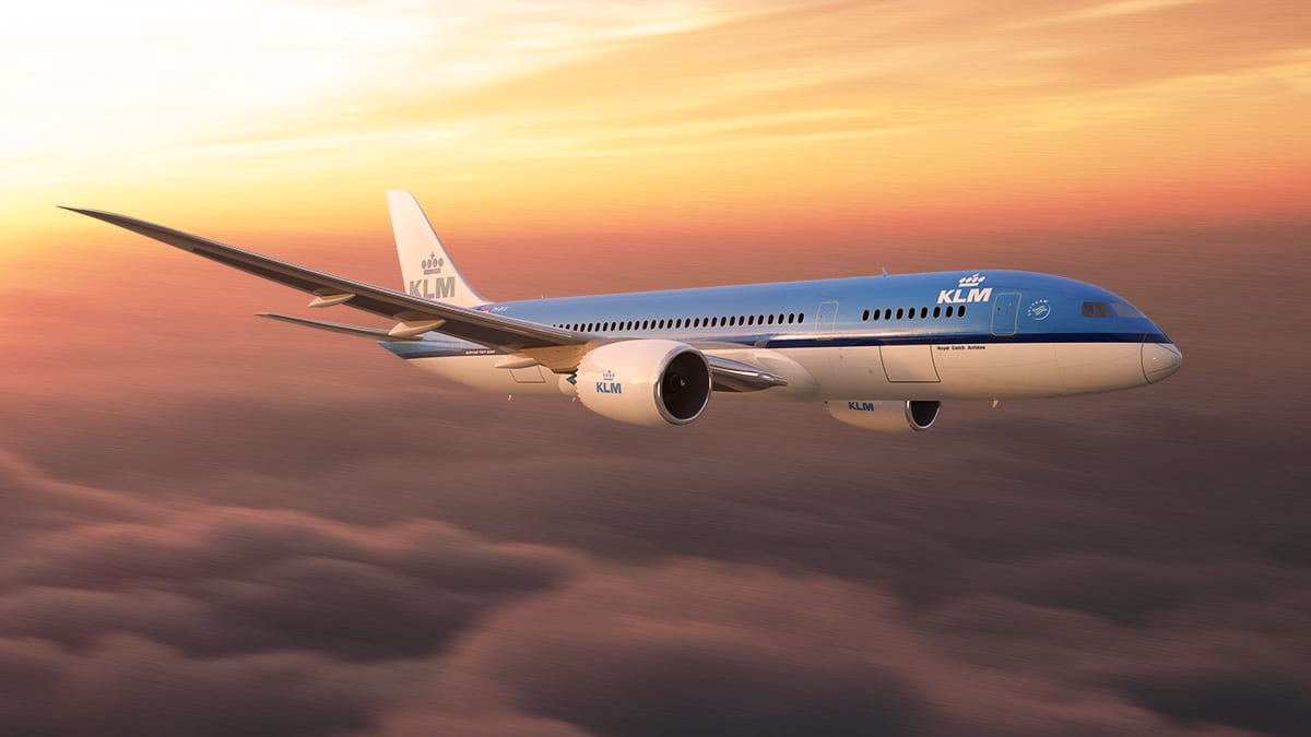 KLM Airplane flying with a sunset in the background