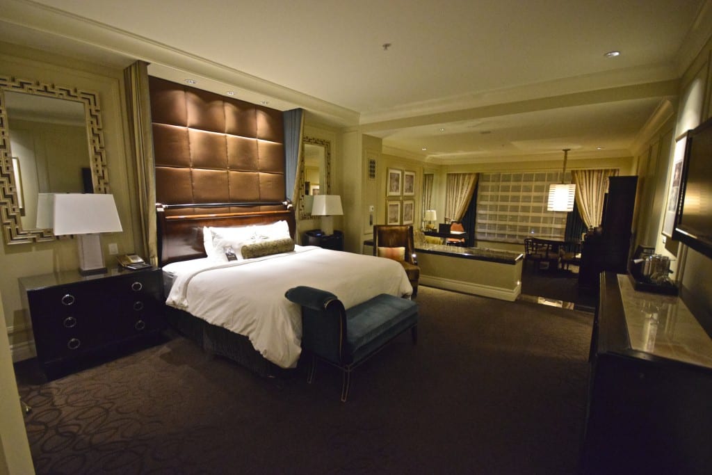 A bedroom with a large bed in a hotel room