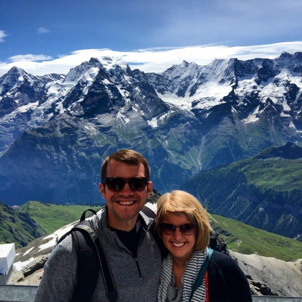 A couple standing in front of a mountain