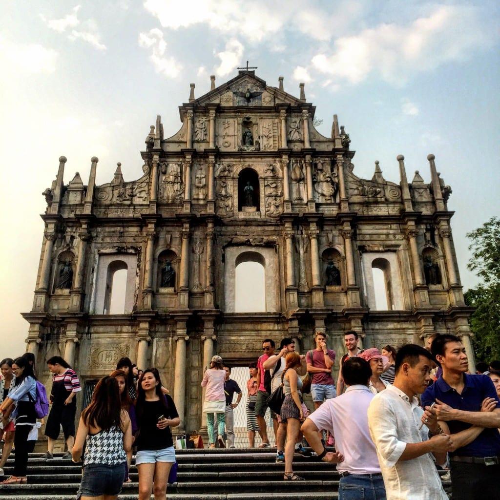 A group of people standing in front of Ruins of St. Paul\'s