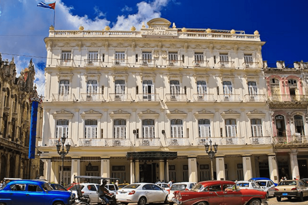 cars parked in front of a building in Cuba