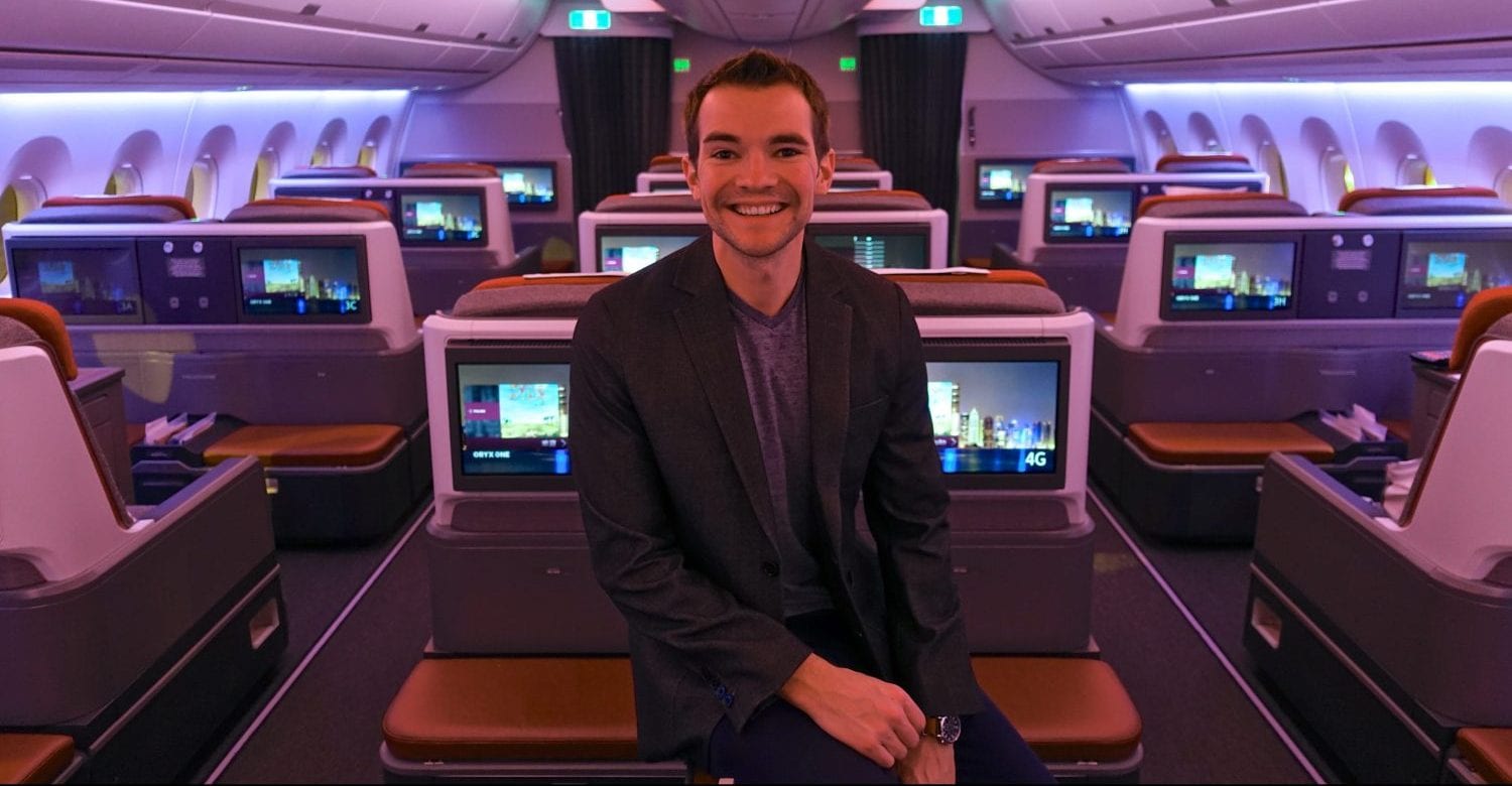A person standing in a business class cabin