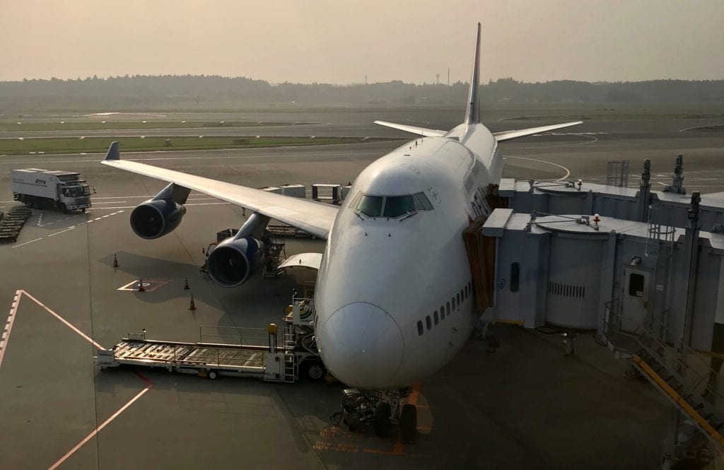 A large passenger jet sitting on top of a tarmac at an airport