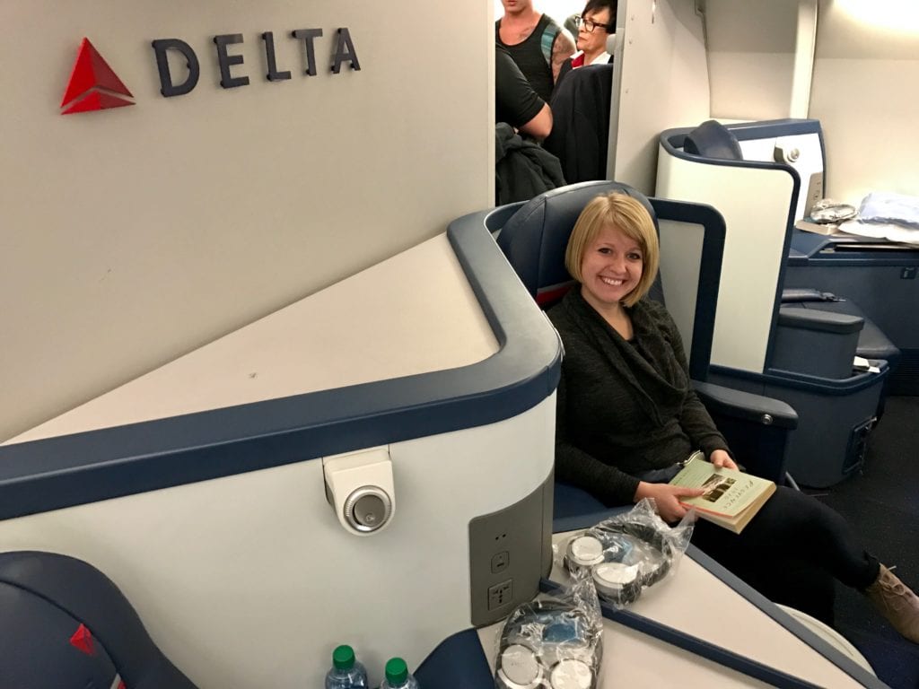 a woman sitting in delta business class