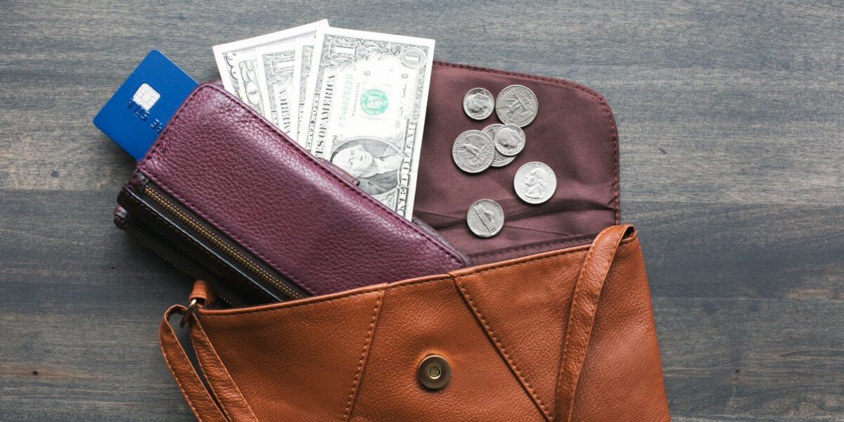 brown leather wallet with cash and credit cards