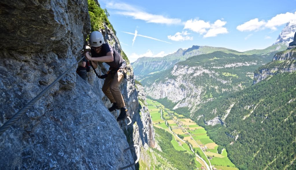 A man climbing on top of a mountain