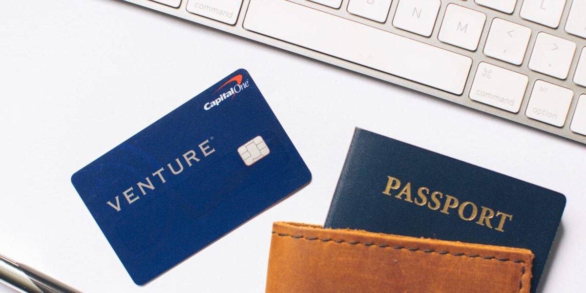 Capital One Venture on tabletop with passport in holder