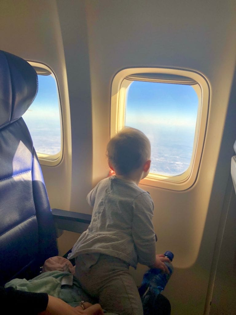 a child looking out an airplane window