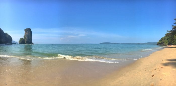 A sandy beach next to a body of water