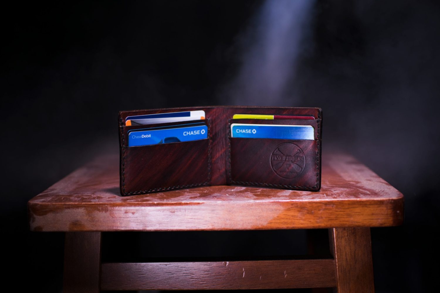 a wallet with credit cards on a wooden table