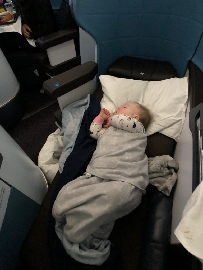 a baby in a klm business clas seat