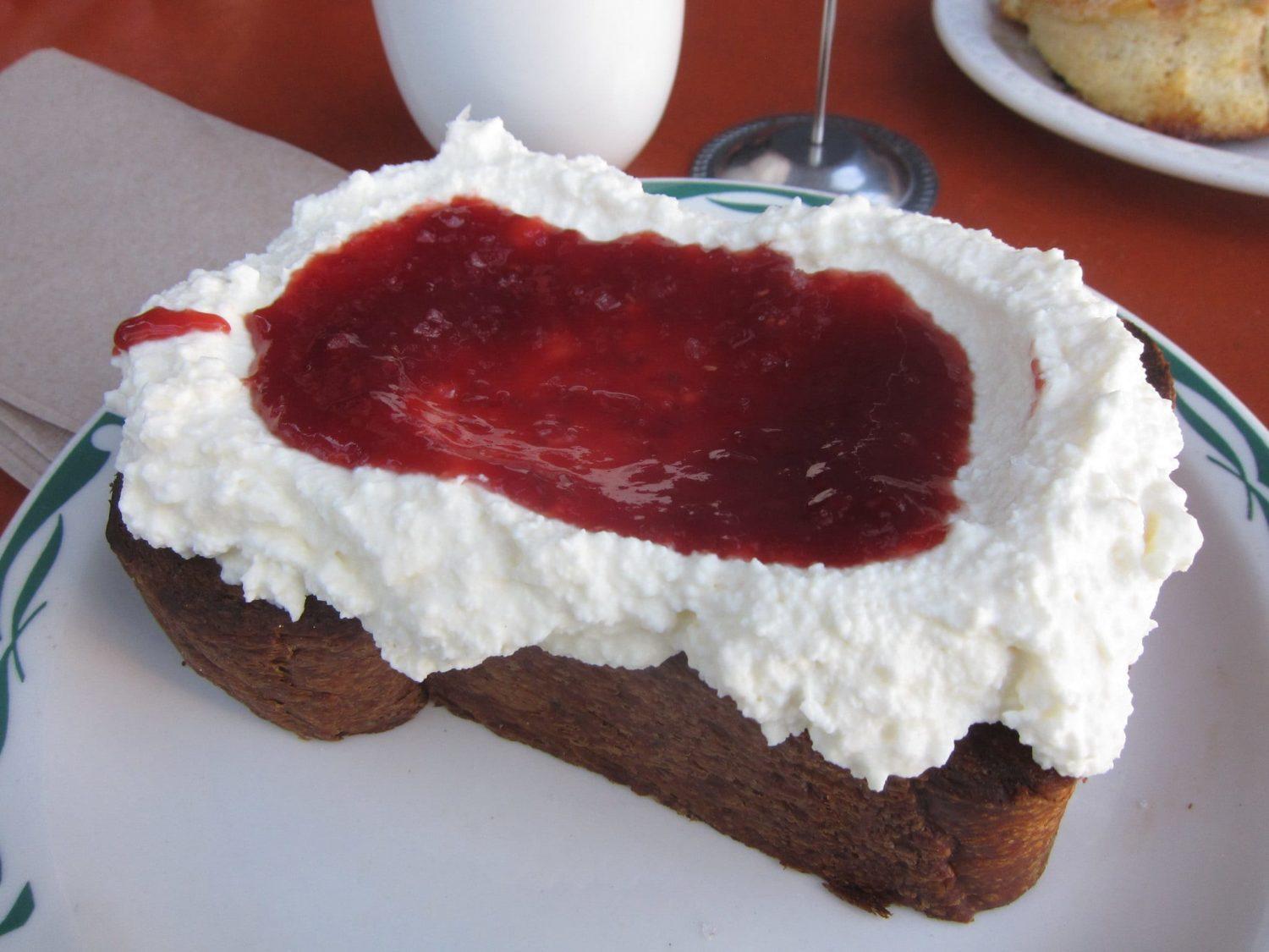 A close up of a piece of cake on a plate, with Cream