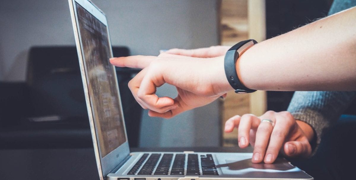 People pointing at a computer screen