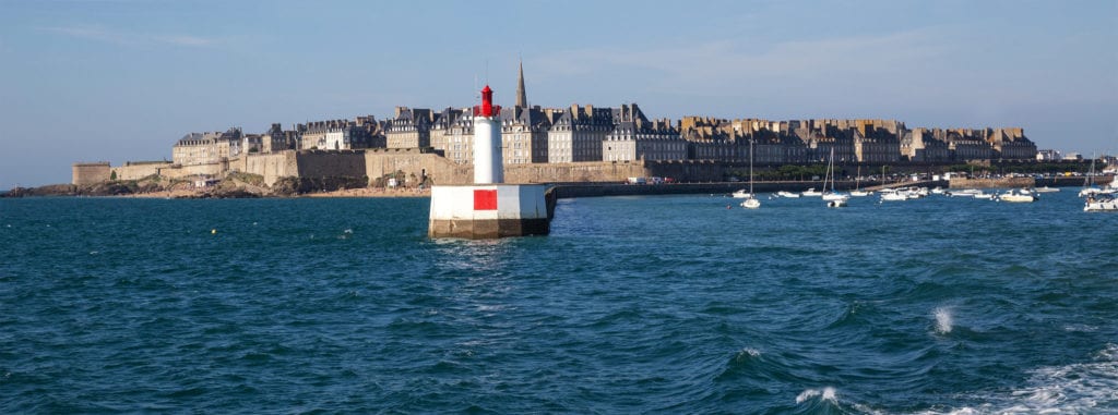 A large body of water with a city in the background