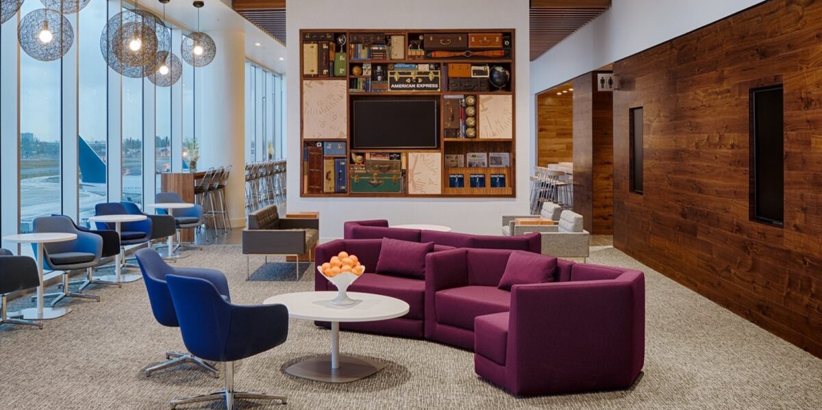 couch and chairs in front of wooden bookcase display