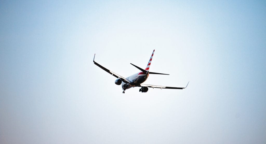 A large airplane flying high up in the air