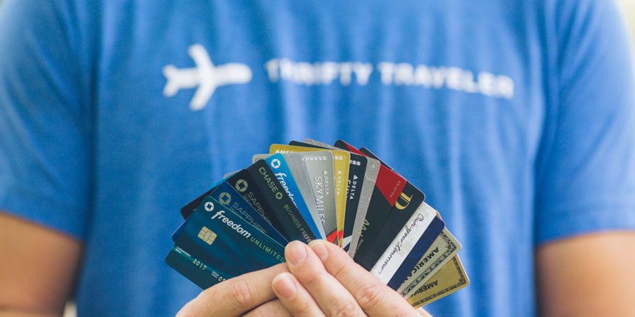 a man in a blue shirt holding credit cards