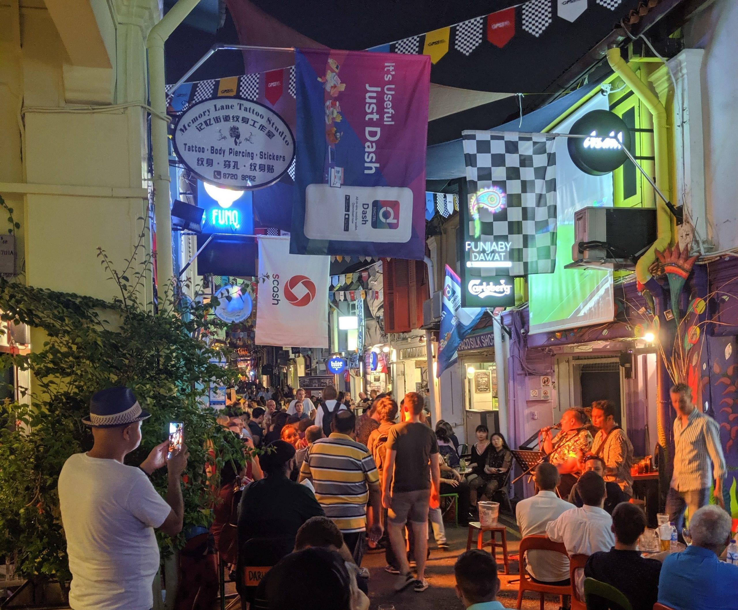 A group of people walking down a street