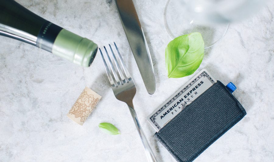 amex platinum card in a wallet on a table with a fork