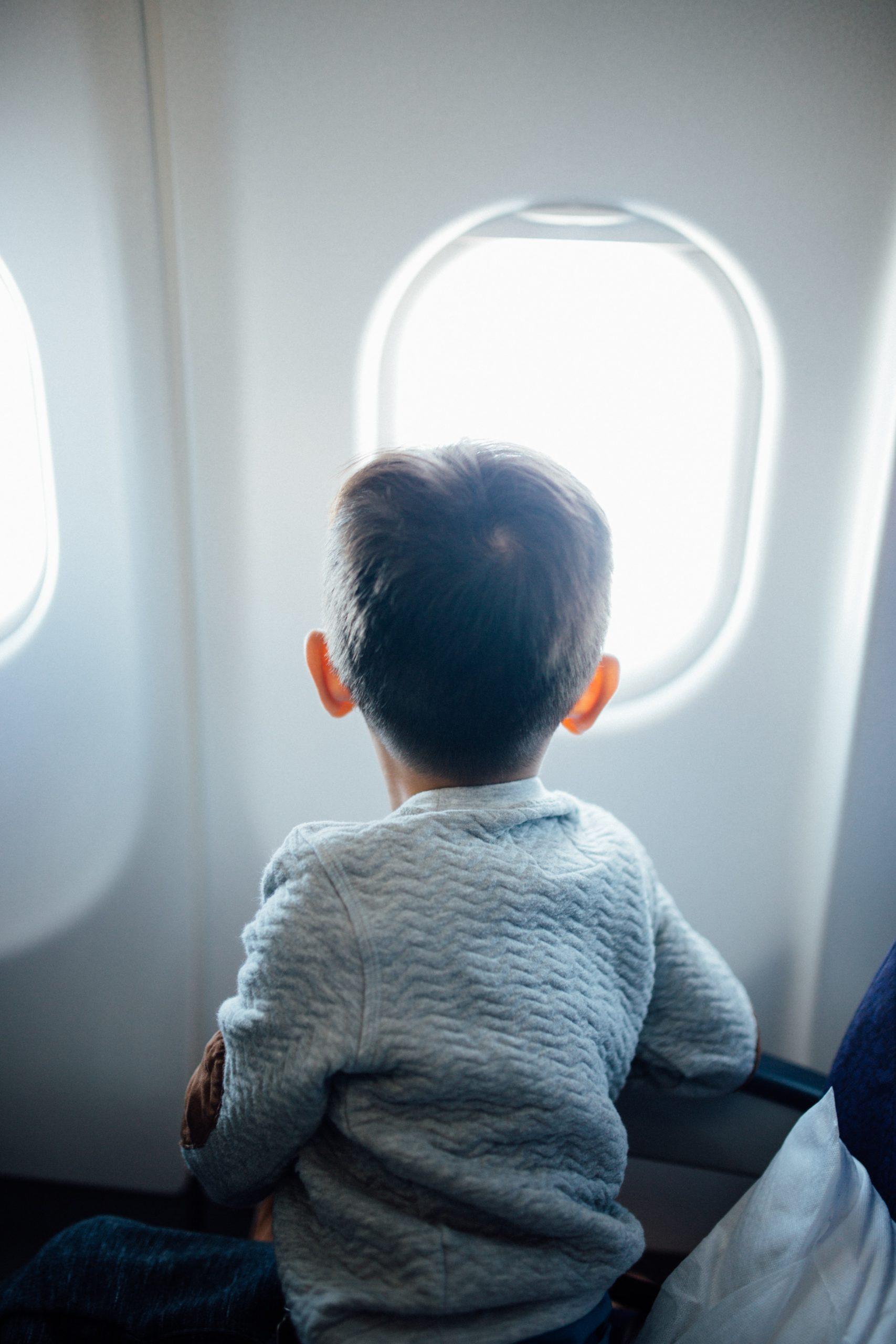 child sitting in plane seat