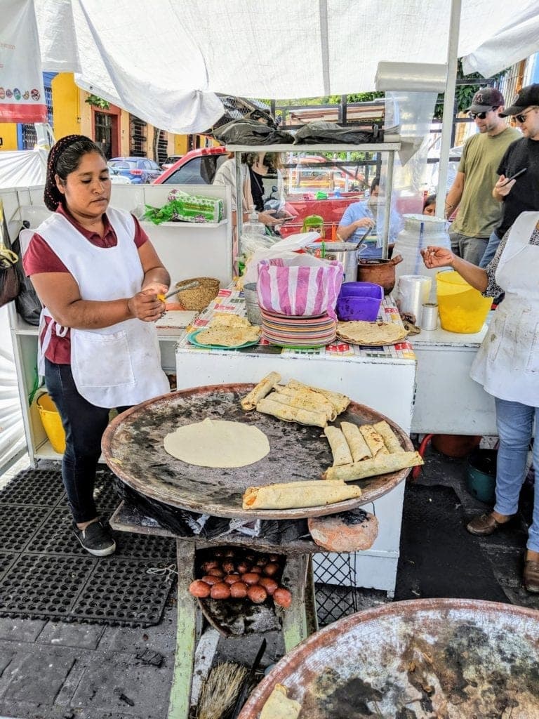 A man and a woman standing in front of a plate of food