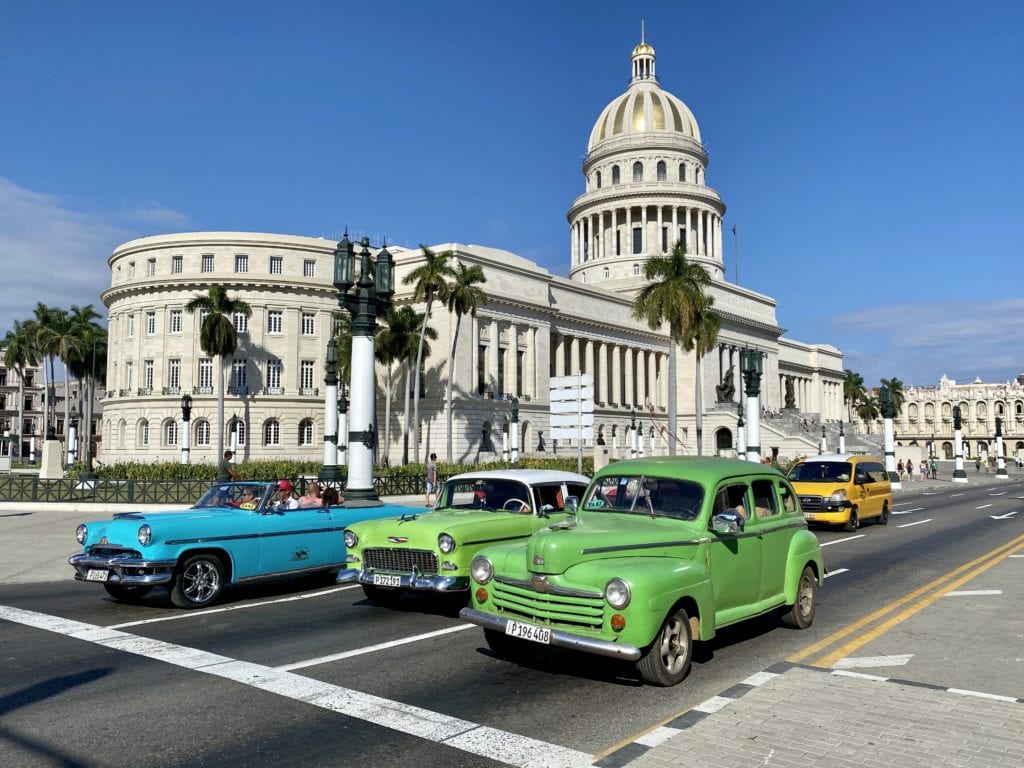 A vibrant display of vintage automobiles lining the streets, capturing the essence of Havana's rich automotive history.