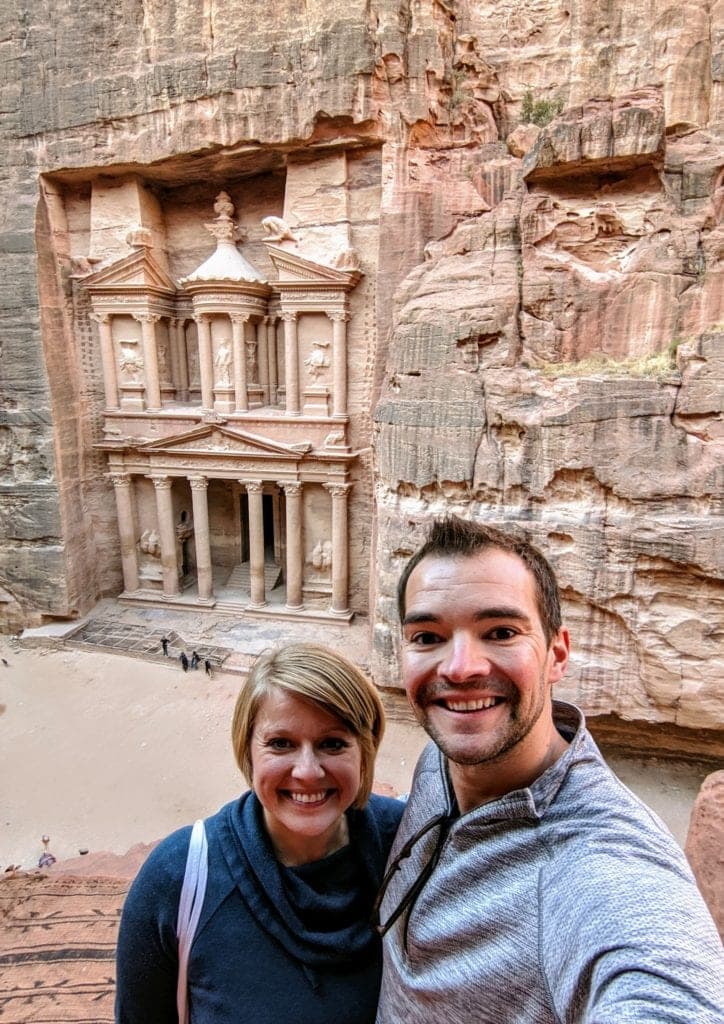 A couple standing in front of a building in Petra