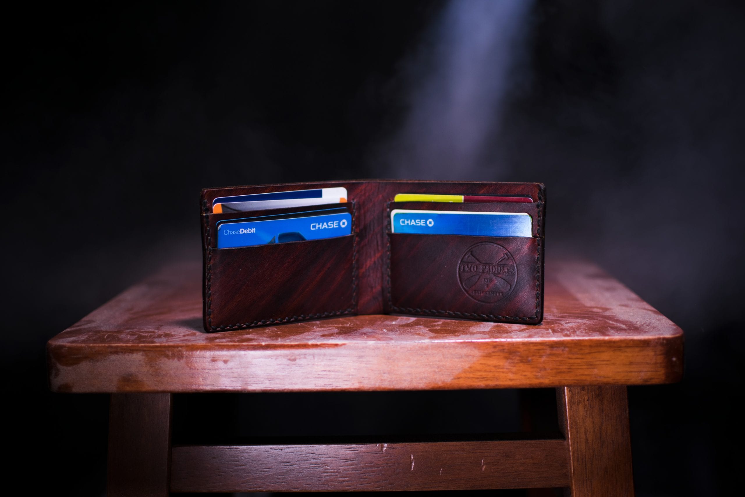 a wallet with credit cards on top of a wooden table