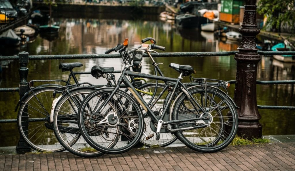 A bicycle parked in front of a canal
