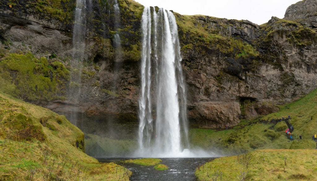 A large waterfall over some water