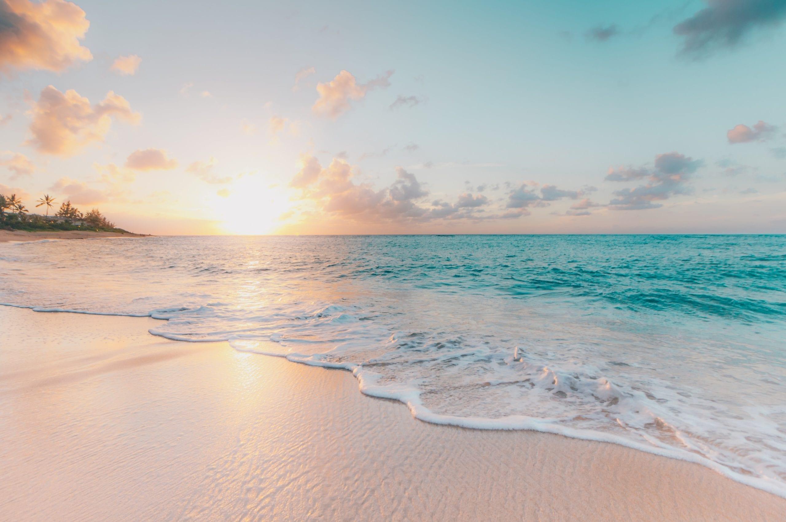 A sandy beach next to a body of water