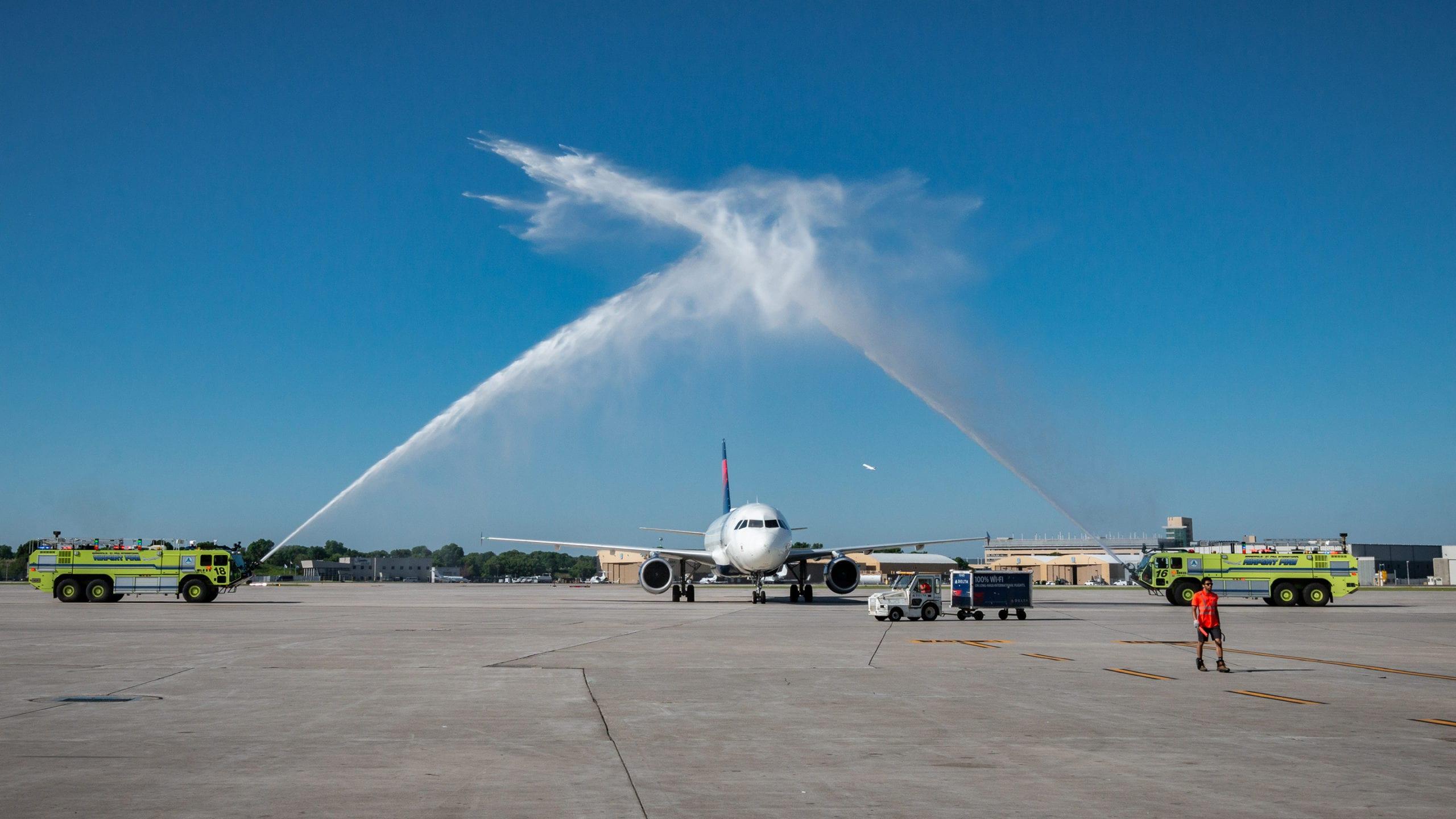 an airplane with a water cannon salute