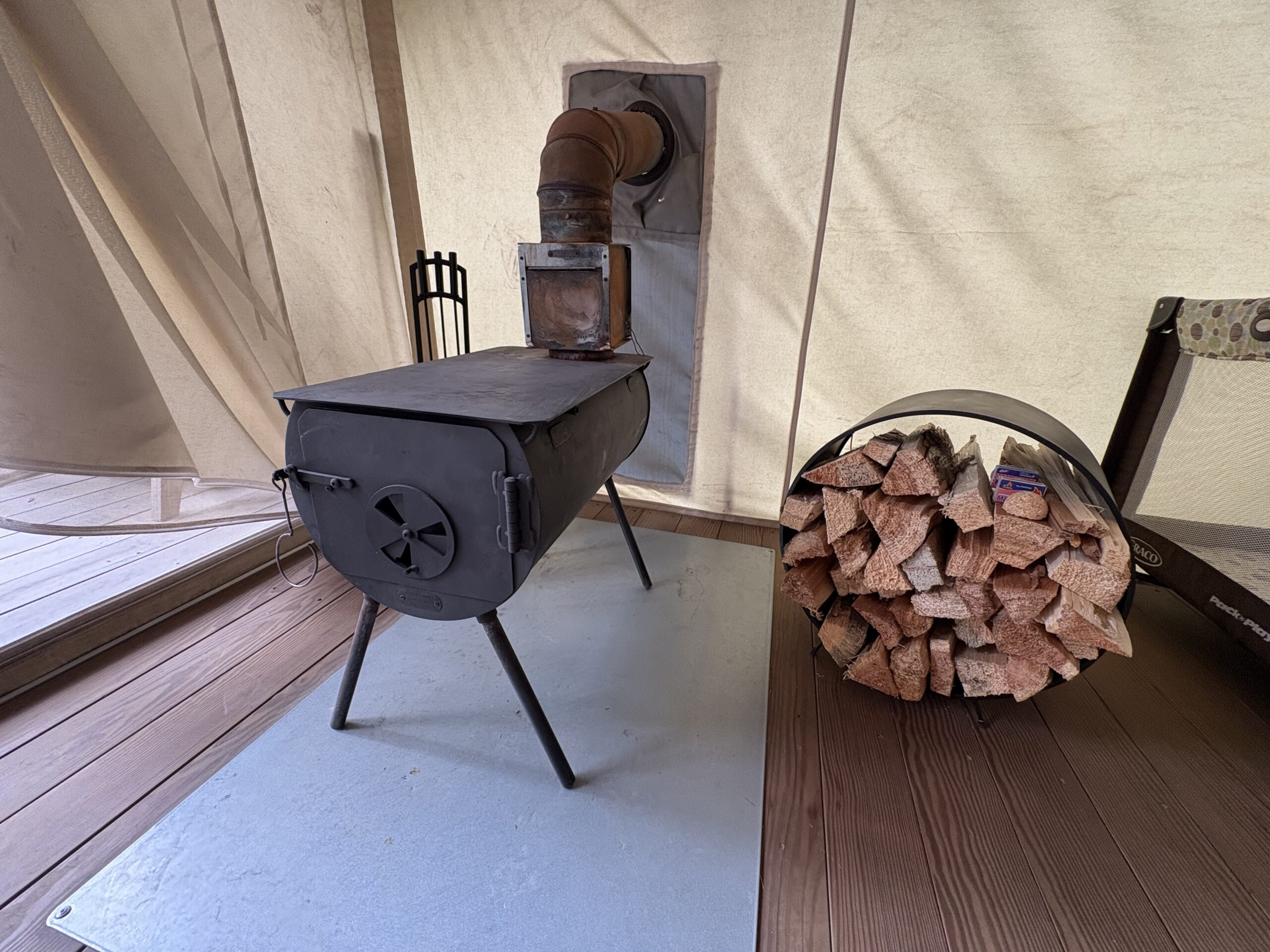 Wood-burning stove in a campsite at Under Canvas Glacier