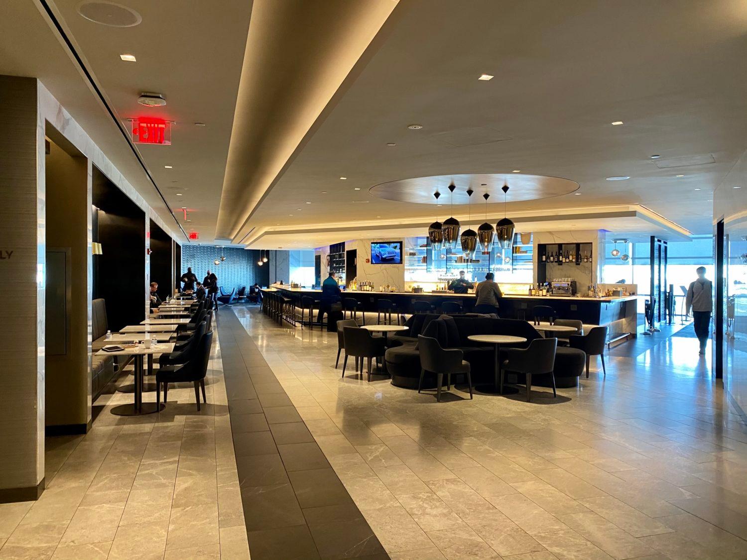 bar and tables inside an airport lounge