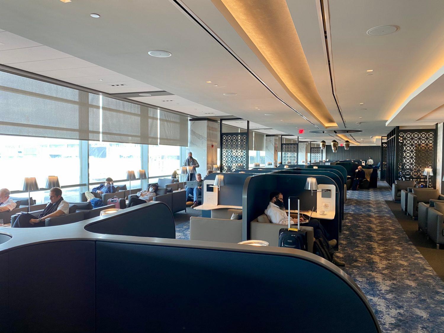 rows of seating and cubicles inside the united newark polaris lounge