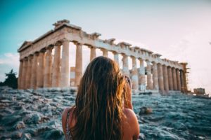 Woman taking a photo of ruins in Athens, Greece