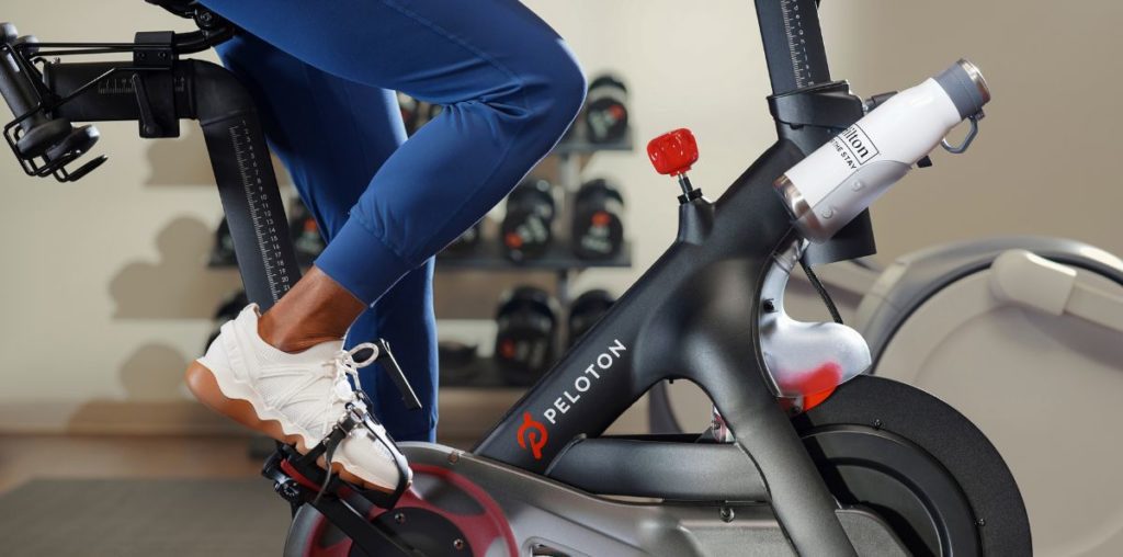 I Was Ready to Cancel My Chase Sapphire Reserve … Then I Did the Math 3 a person pedaling a Peloton bike with a Hilton water bottle.