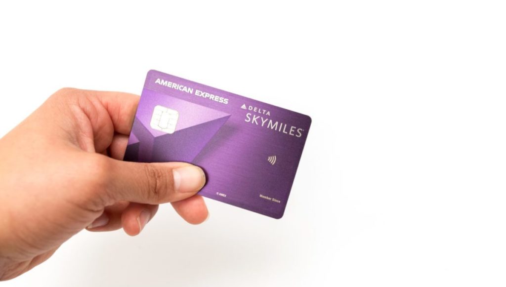 a person holding the delta reserve card