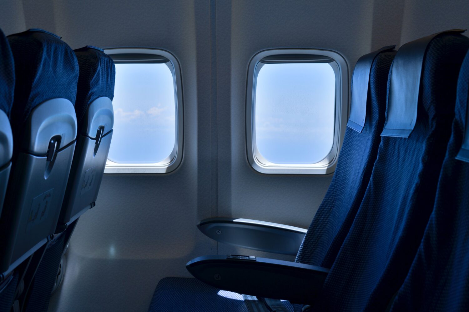 Unoccupied seats on plane with clear blue sky