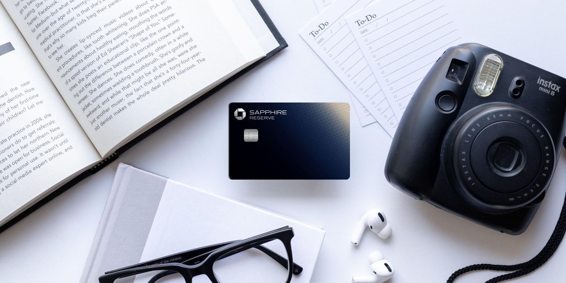 Chase Sapphire Reserve Card with a camera, book, to-do list, glasses, and airpods.