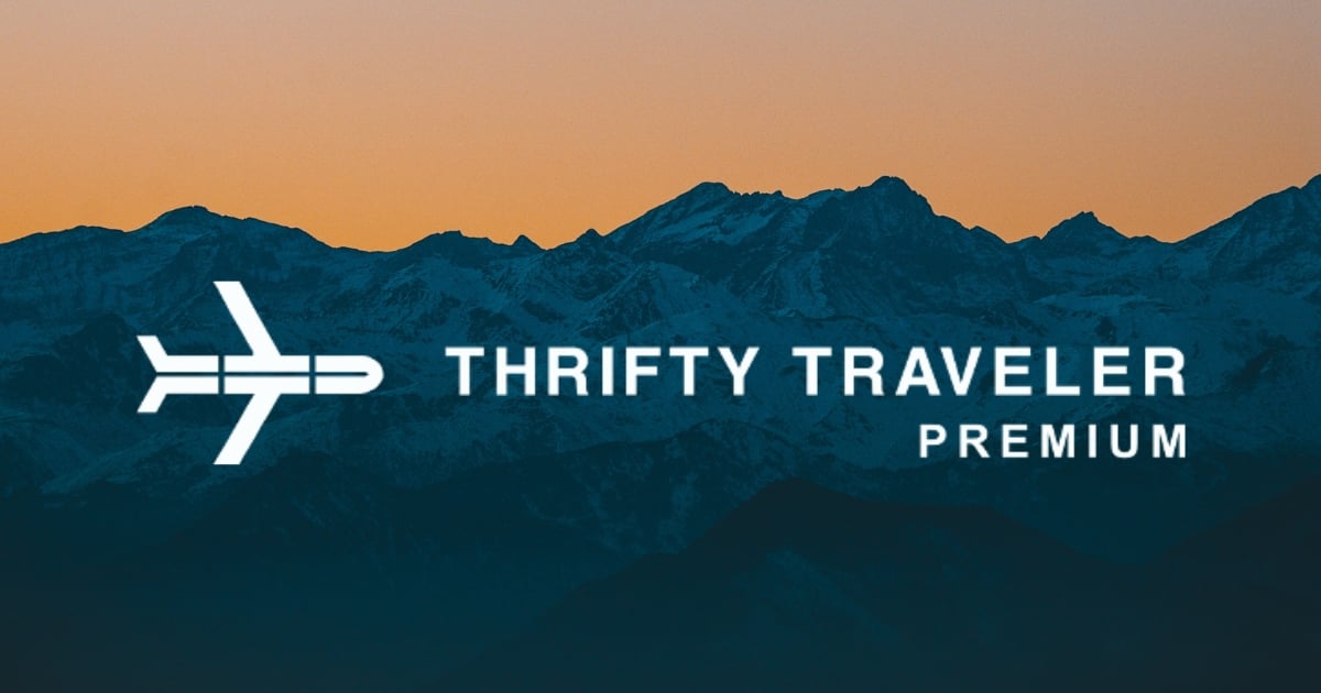 Thrifty Traveler Premium logo in front of mountains