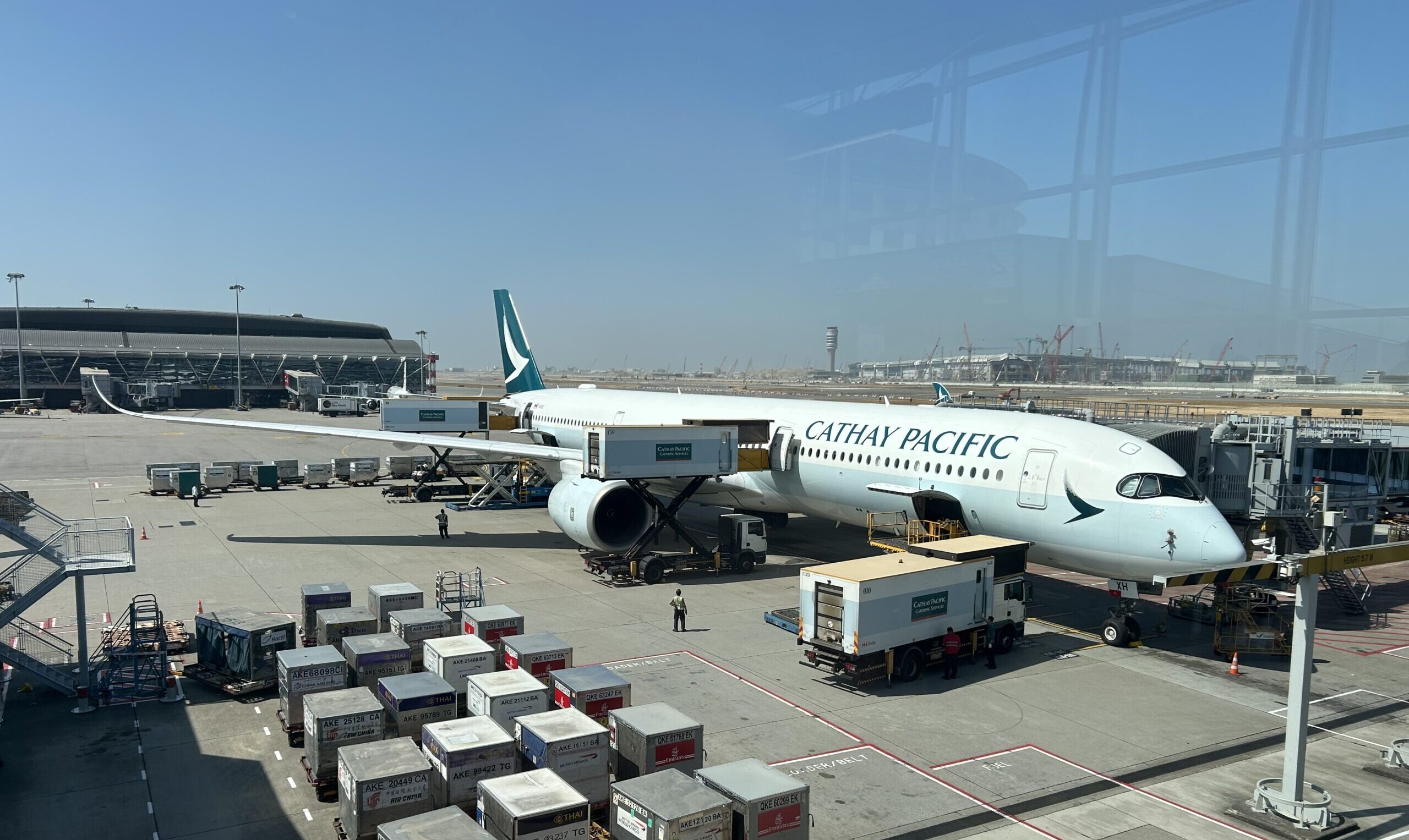 cathay pacific plane sitting at a gate