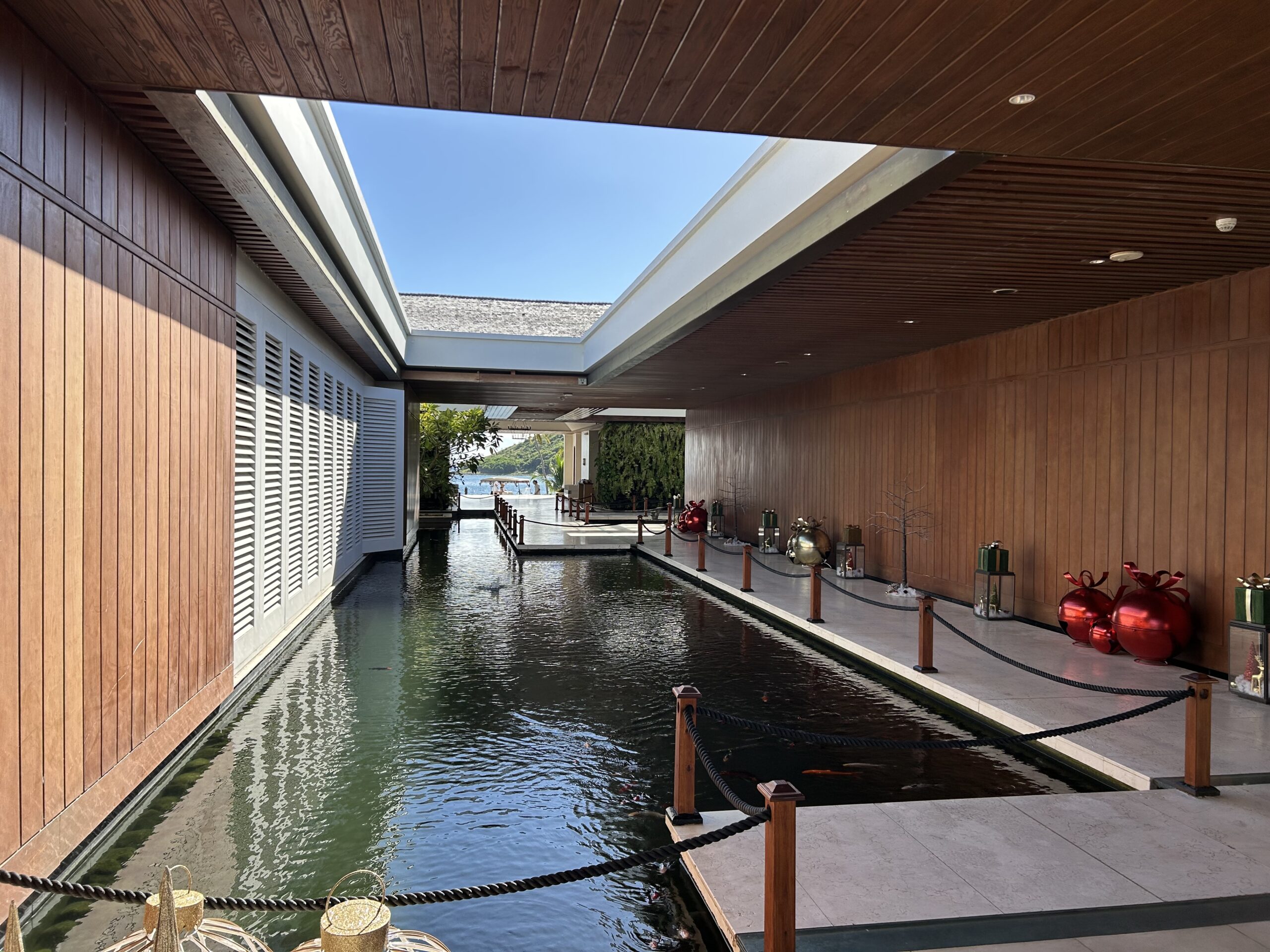 Coi Pond at the entry to a luxury hotel with wood-paneled walls