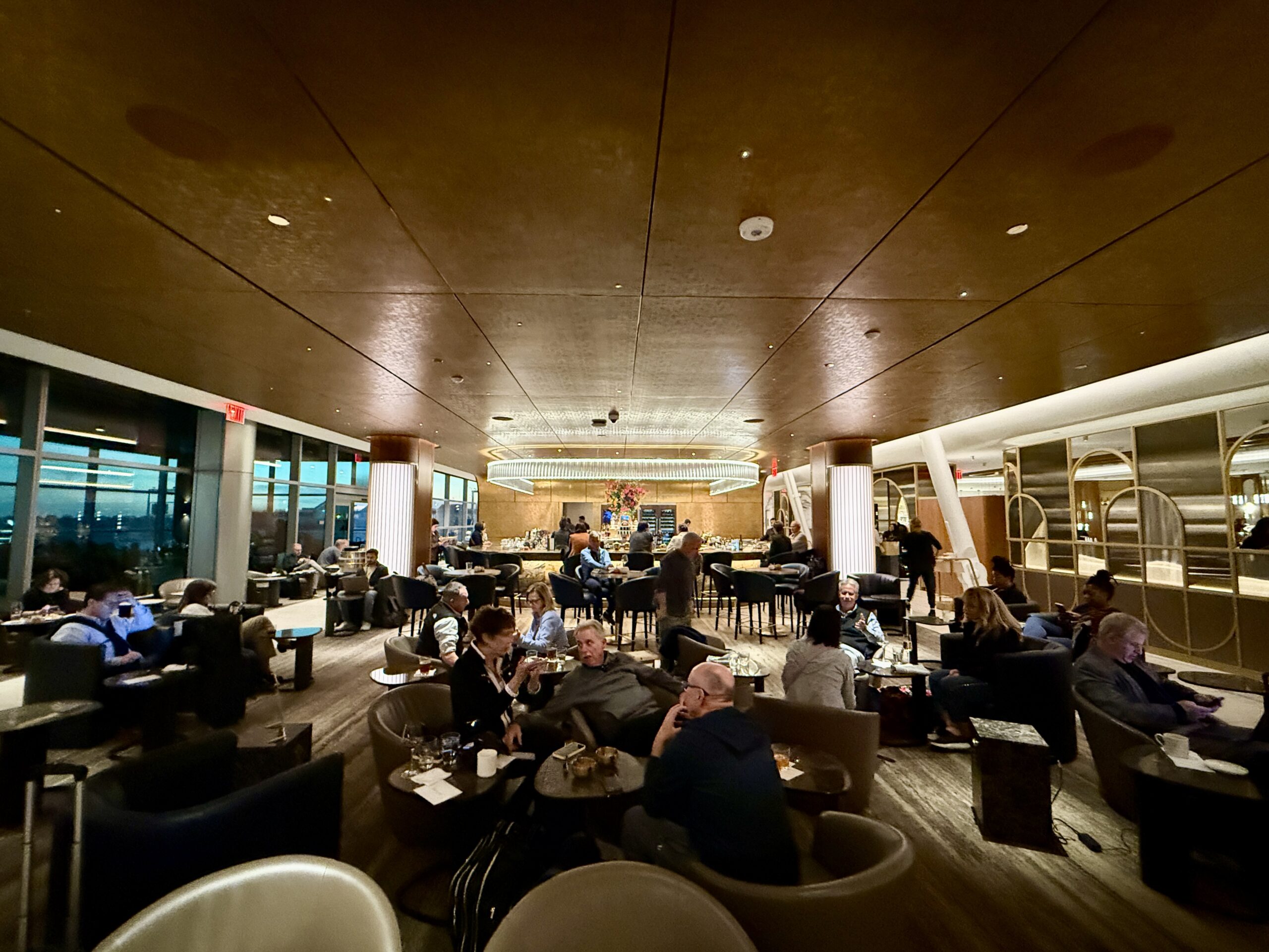 crowded bar area with many people in seats