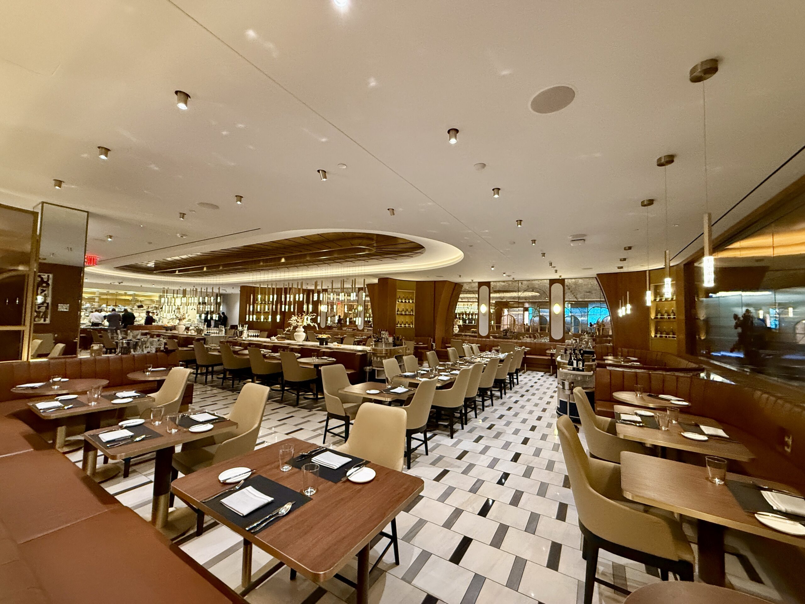 restaurant inside airport lounge with many tables set