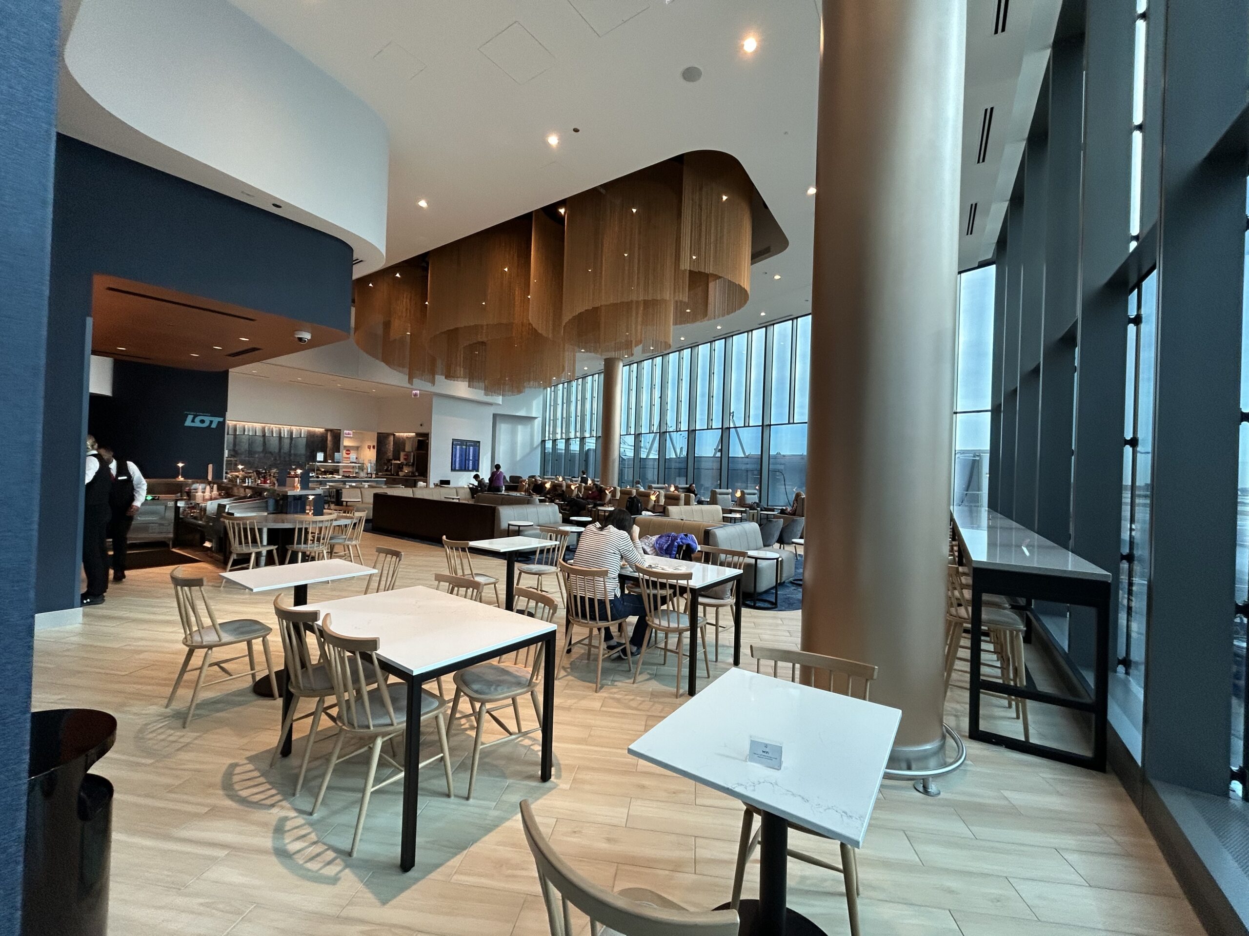 Dining area tables with the bar behind it