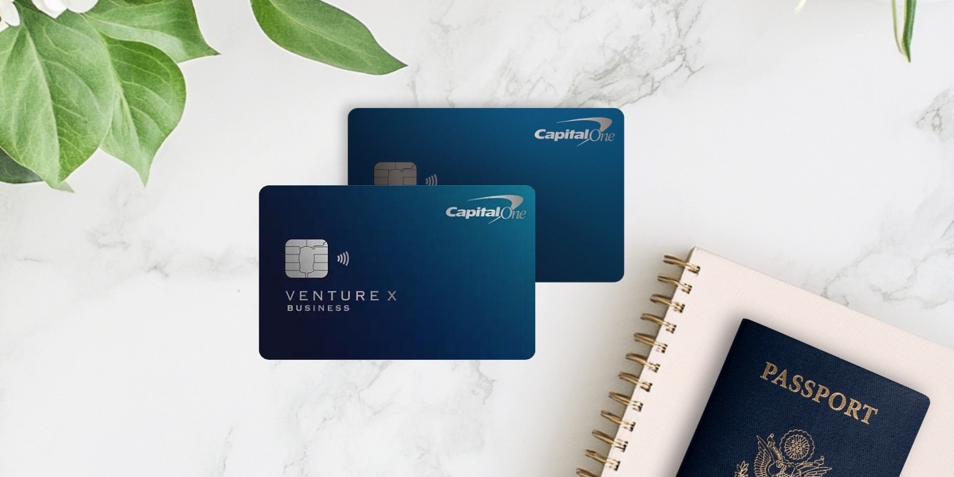 Venture X and Venture X business cards with a floral arrangement, notebook, and passport.