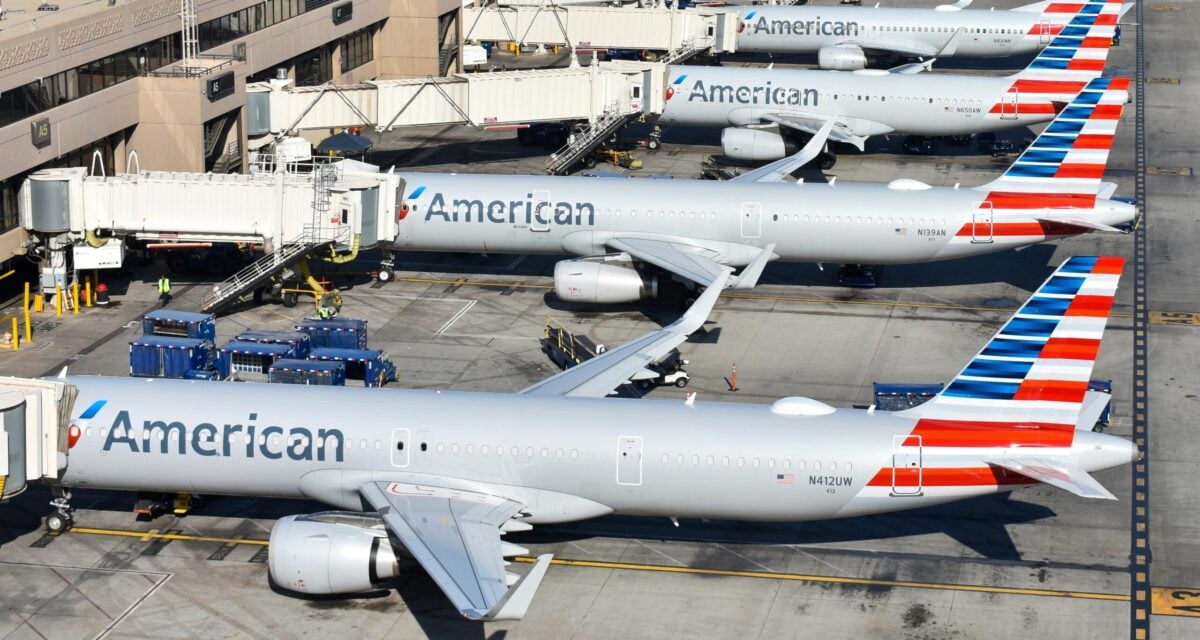 four american airlines jets parked at gates