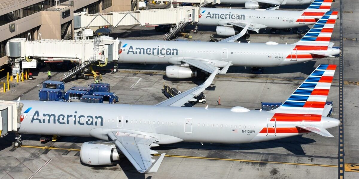 four american airlines jets parked at gates